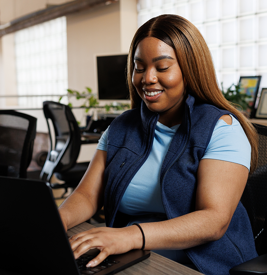 woman working on laptop in open office space